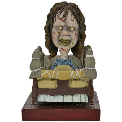 The Exorcist Regan In Bed Head Knockers Bobblehead Figure. Stands 5.5 inches tall with bobbling bed and bobbling head, and comes in collectible matte packaging with spot gloss finish.
